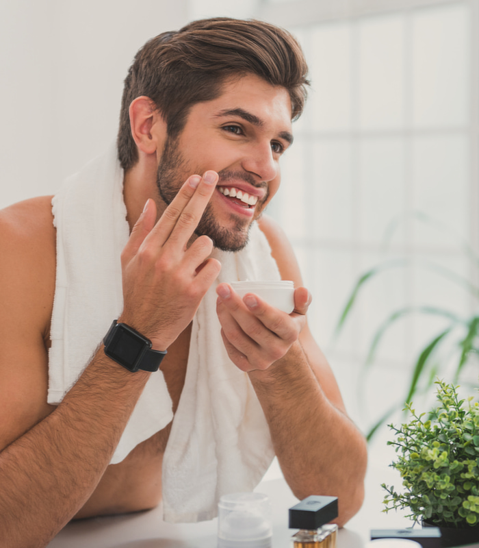 man applying skin care