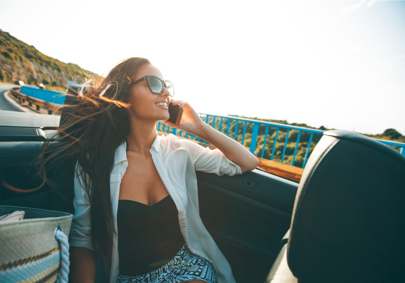 young woman riding in a convertible