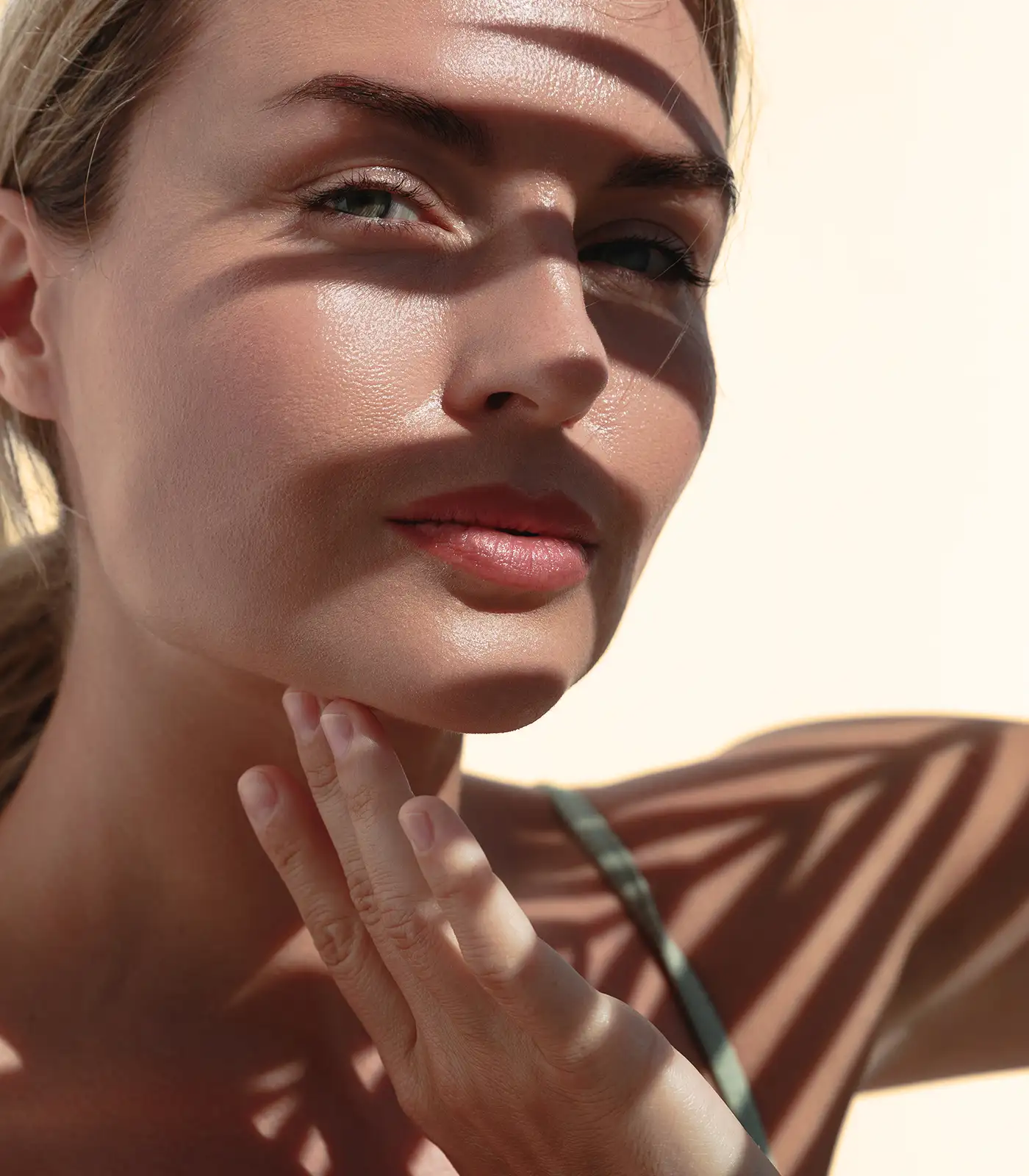 young woman seeking shade to protect her beautiful skin